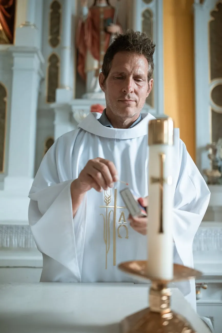 man in white thobe holding white stick