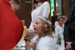 A girl receiving first holy communion 